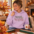 Woman wearing lilac Mahj Weather hoodie in a warm fall mahjong setting