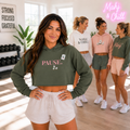 Woman wearing the Pause crop hoodie in military green